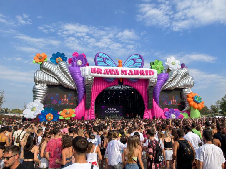 Colorful inflatable festival stage installation with a large audience at an outdoor music event