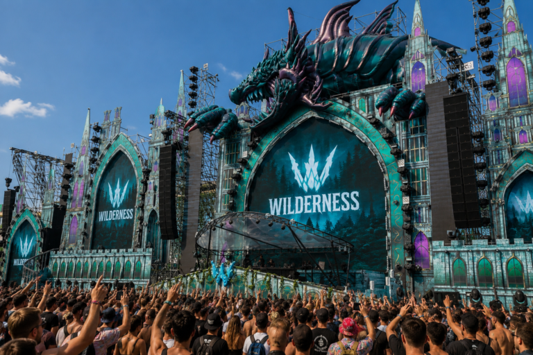 Giant inflatable dragon stage installation at an outdoor music festival