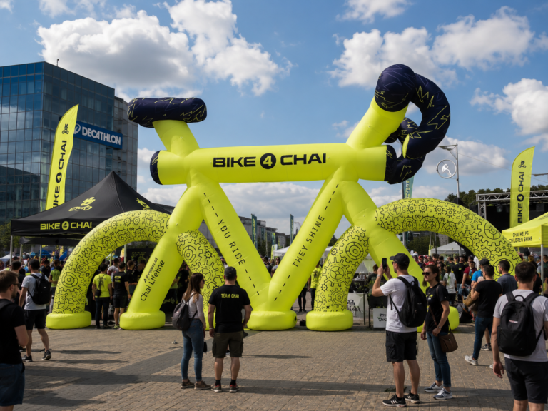 Giant inflatable bicycle installation displayed at an outdoor cycling event