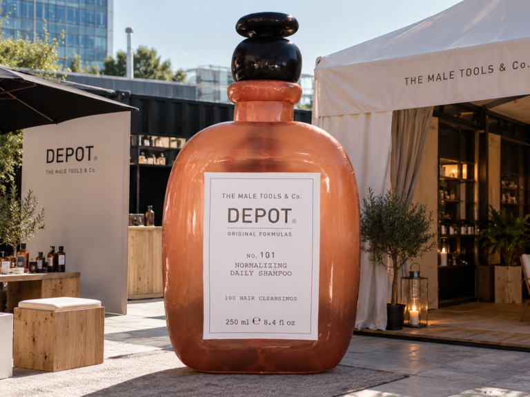 Giant inflatable DEPOT shampoo bottle displayed as a promotional installation at a branded outdoor event
