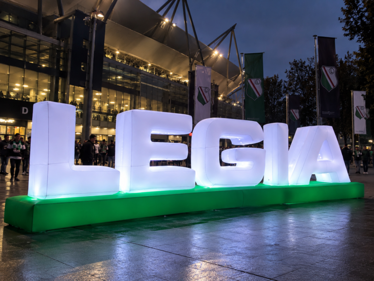 Illuminated inflatable LEGIA letters displayed outside the stadium during a football event