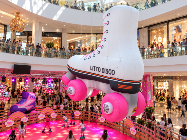 Giant inflatable roller skate suspended above the Litto Disco roller rink at Grand Littoral shopping center